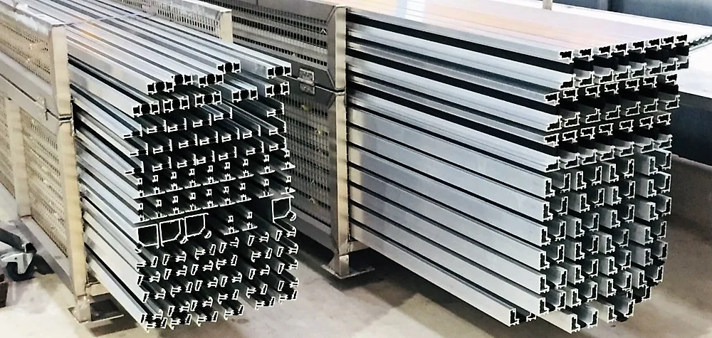 Stacks of raw aluminium extrusions prepared for pre-treatment
